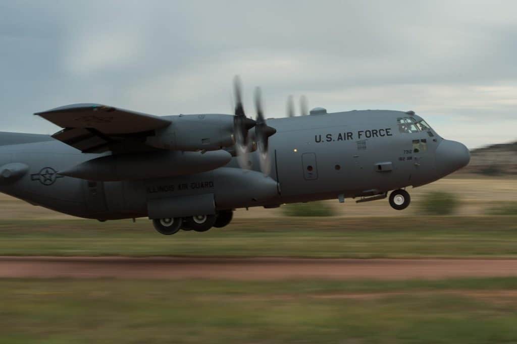 BogiDope, a C-130 executes a takeoff on a dirt strip.