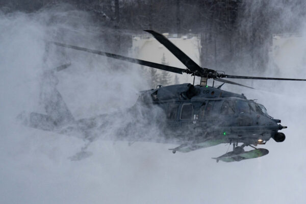 F-22s and HH-60Gs fly over JBER